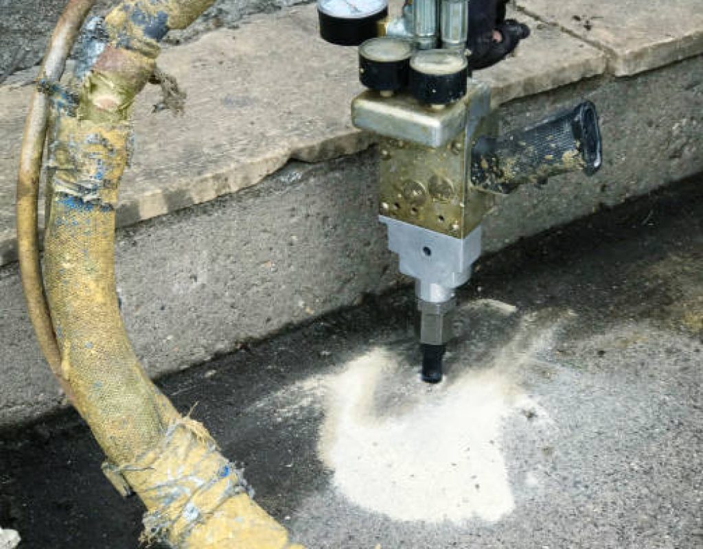 Polyurethane foam injection lifting uneven concrete driveway in Austin, Texas