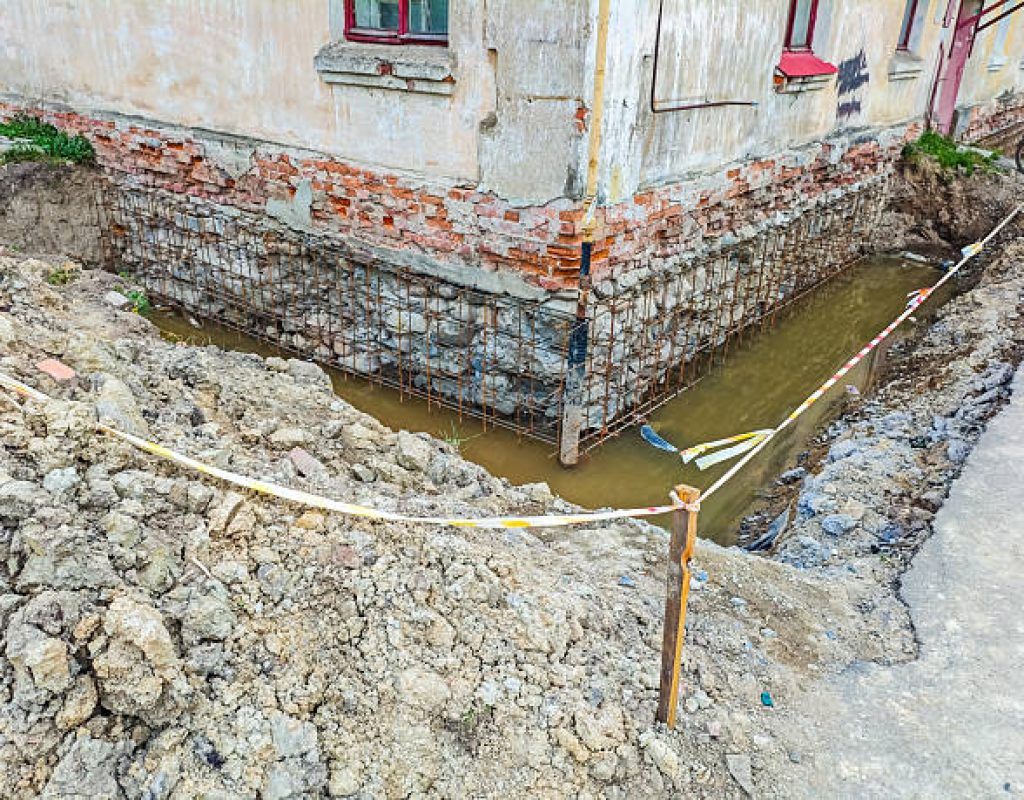 Foundation repair experts correcting structural issues and uneven settlement